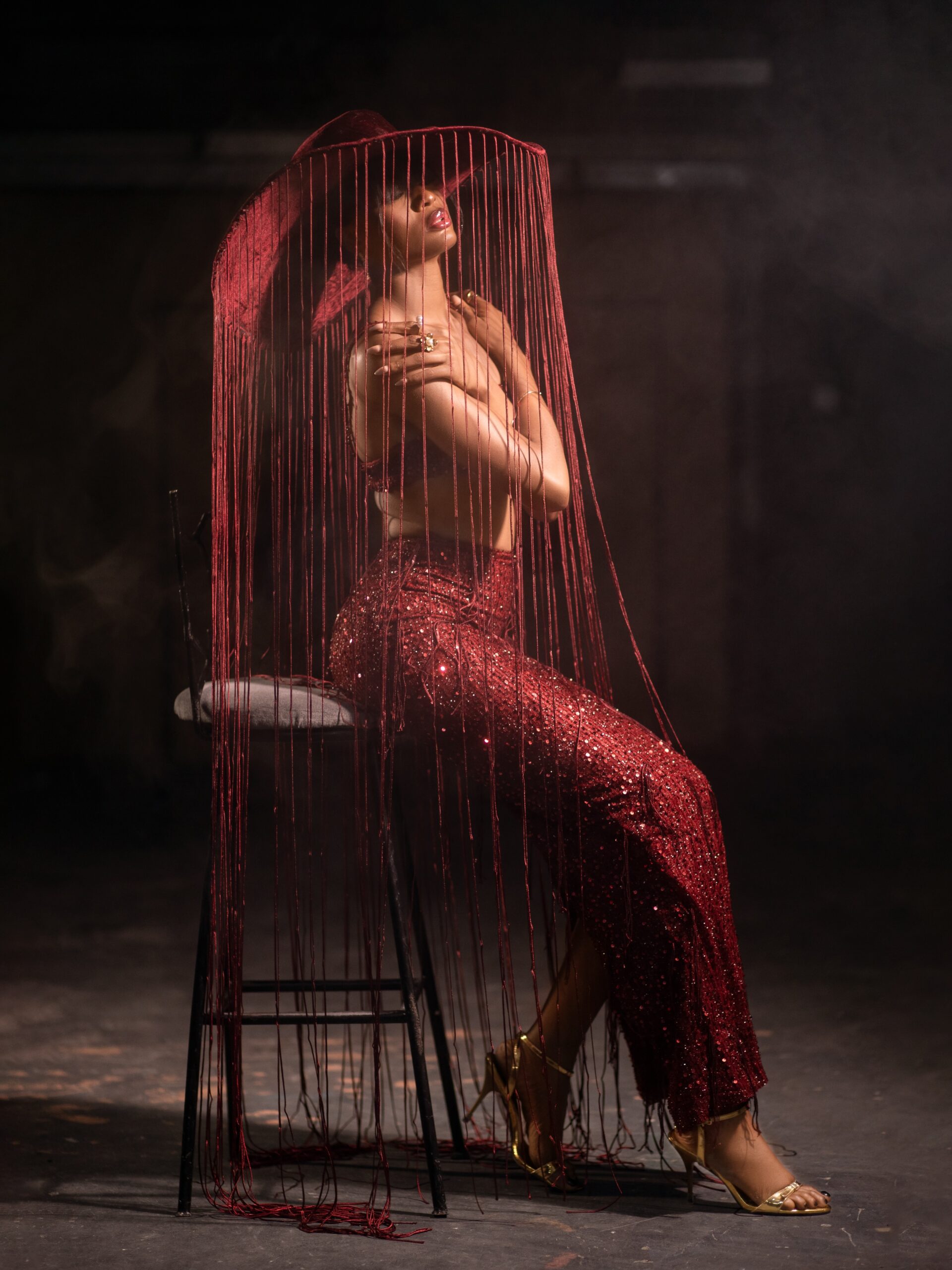 Gift Eno Ndah wearing a red sequined suit and fringed hat for Supra Model of the Year competition at Miss Supranational 2026.