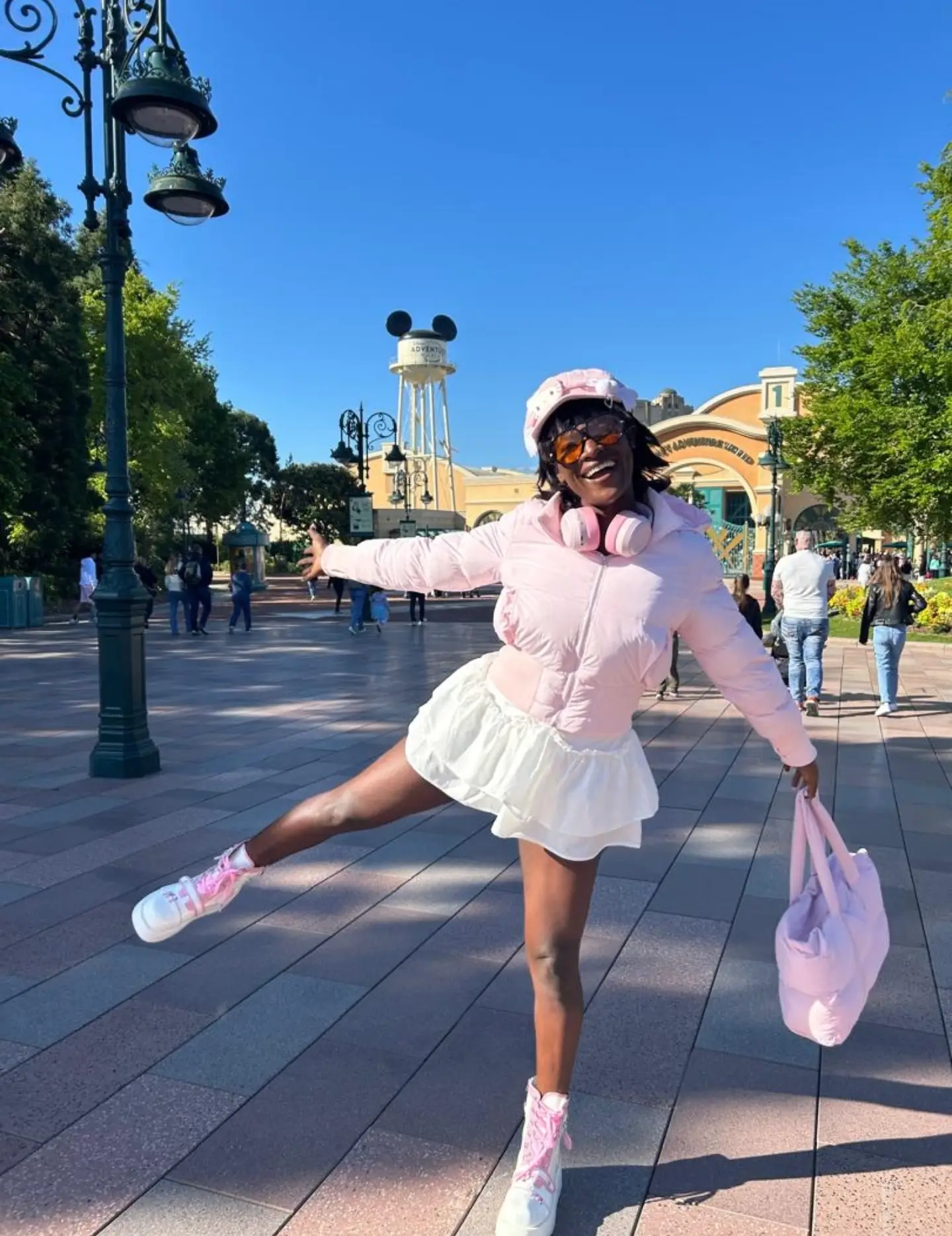 BBNaija Season 11 Week 4 Head of House Abi Ayoola in a pink puffer jacket and white skirt at Disneyland Paris