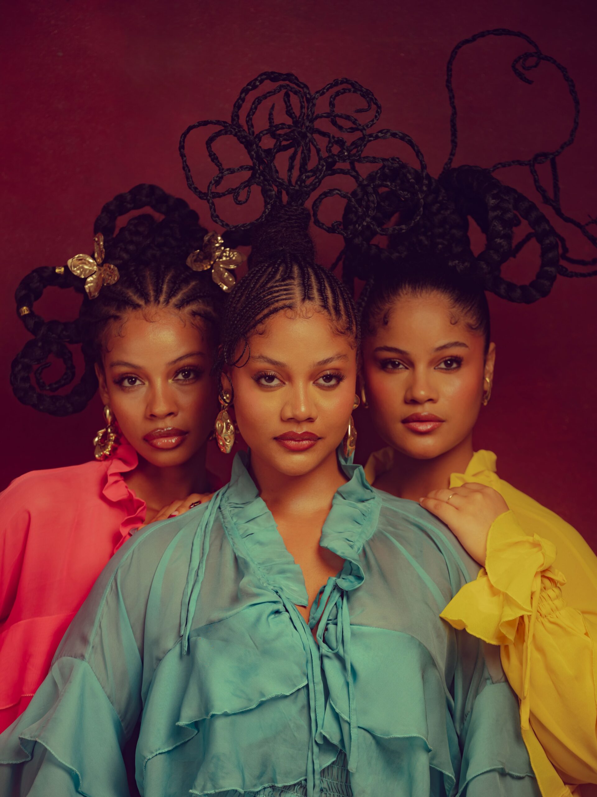Nwadiuto Rosman in coral pink, Honey Rosman in aqua teal, and Sunshine Rosman in canary yellow featuring wire-structured braided hairstyles.