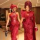 Nigerian actress Iyabo Ojo and her daughter Priscilla Ojo posing in matching crimson red beaded lace Asoebi dresses with traditional Gele headties.
