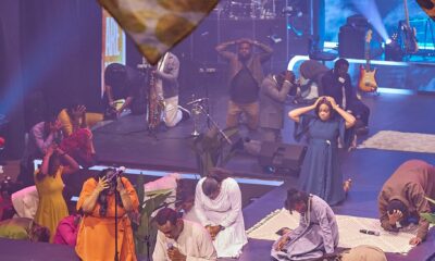 Nathaniel Bassey kneeling in worship during The Battle Belongs to God live recording