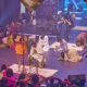 Nathaniel Bassey kneeling in worship during The Battle Belongs to God live recording