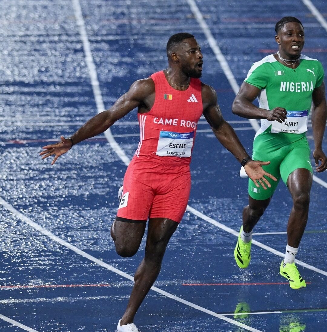Cameroon sprinter Emmanuel Eseme crossing the finish line ahead of Nigeria sprinter Kayinsola Ajayi in the men's 100m final at Glasgow 2026.