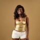 BBNaija Season 11 Week 4 Head of House Abi Ayoola in a metallic gold top and white shorts for a studio portrait