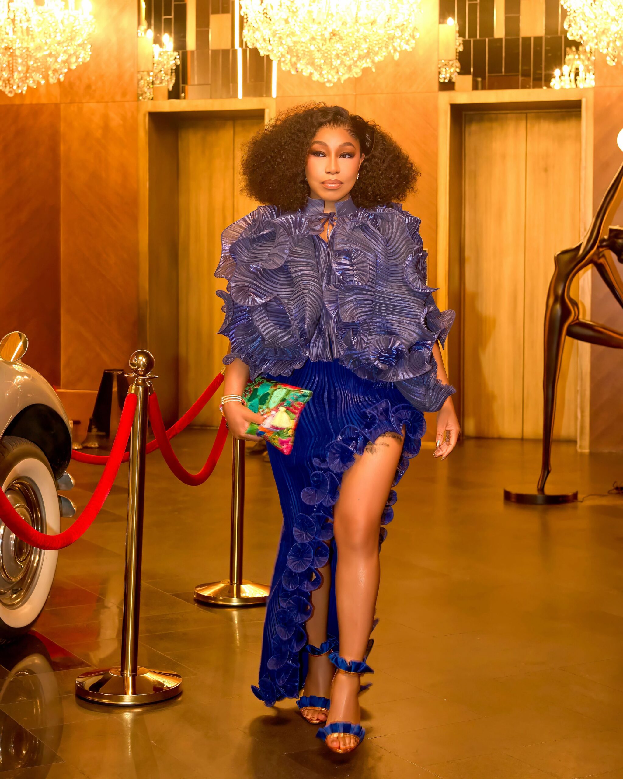 Nollywood actress Rita Dominic wearing a royal blue metallic ruffled top and matching high-slit pleated skirt for her birthday dinner hosted by husband Fidelis Anosike.