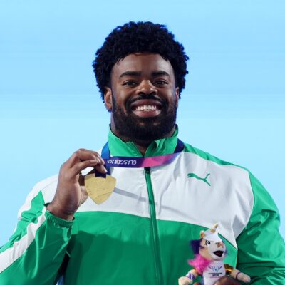Chukwuebuka Enekwechi holding his gold medal and official mascot at the 2026 Commonwealth Games in Glasgow.