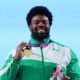 Chukwuebuka Enekwechi holding his gold medal and official mascot at the 2026 Commonwealth Games in Glasgow.