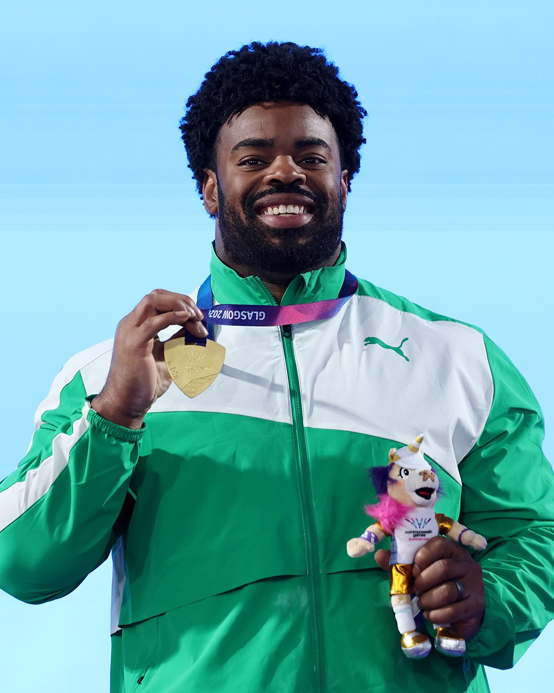 Chukwuebuka Enekwechi holding his gold medal and official mascot at the 2026 Commonwealth Games in Glasgow.