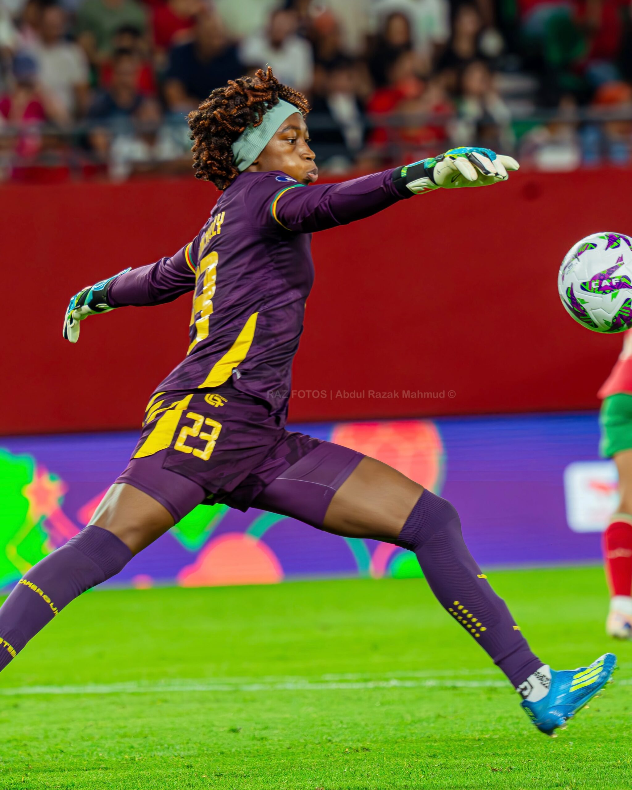 Cameroon goalkeeper Michaely Bihina diving mid-air to deflect the ball during a WAFCON match in Morocco.