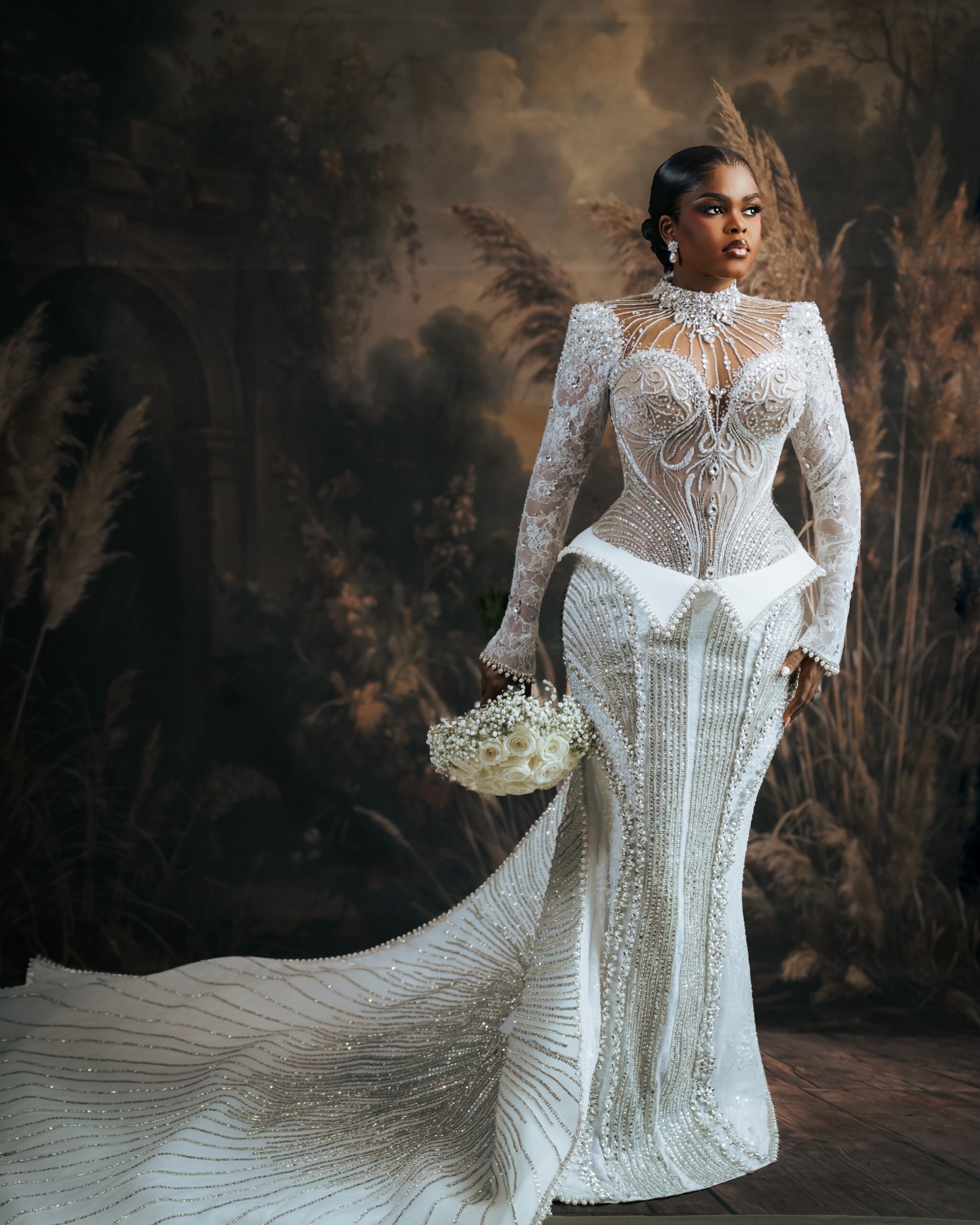 Jarvis posing in a heavily beaded Veekee James wedding dress with a dramatic train.