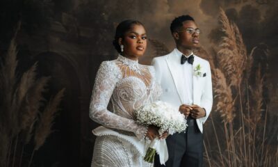 Peller and Jarvis posing together in their white wedding outfits.