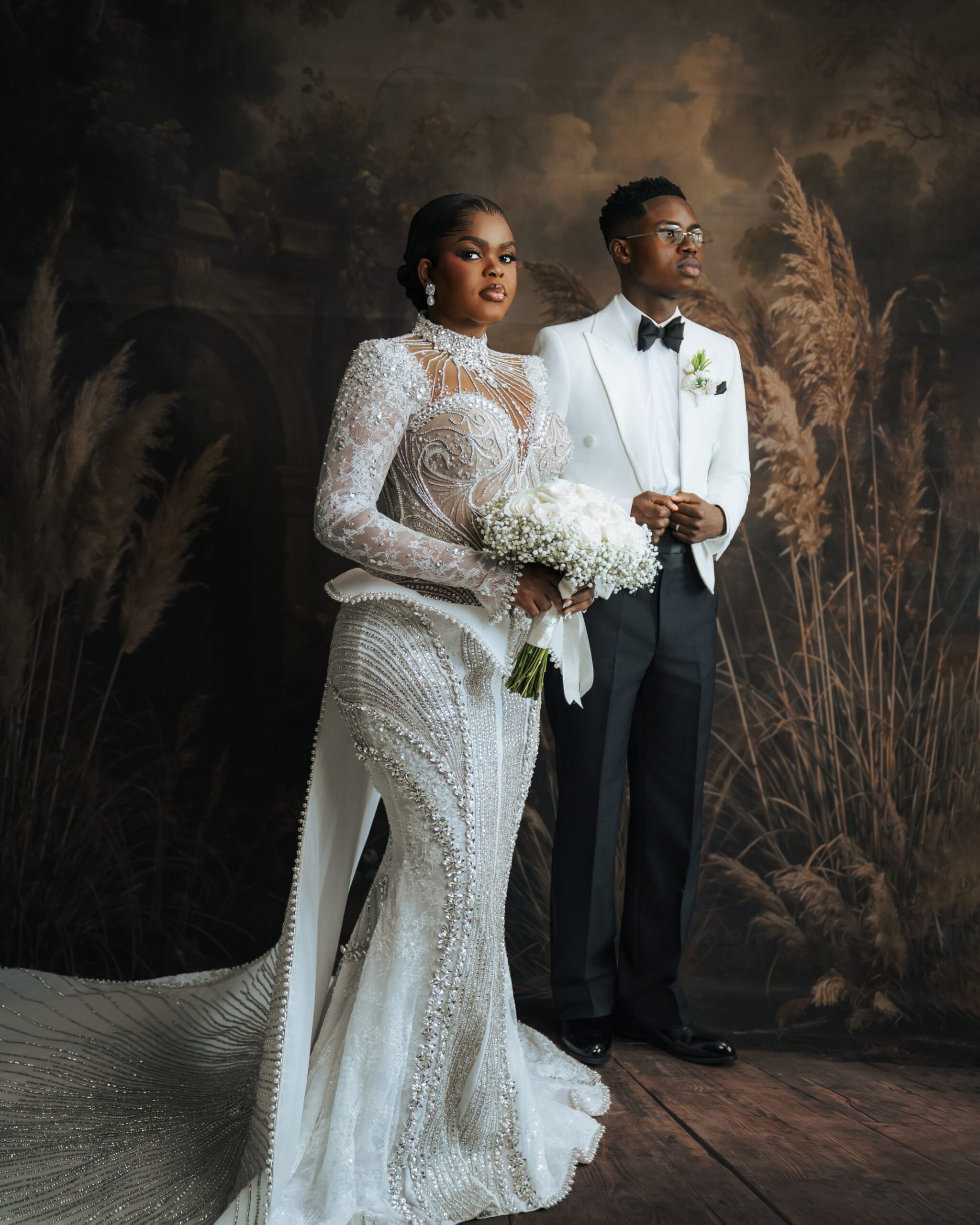 Peller and Jarvis posing together in their white wedding outfits.