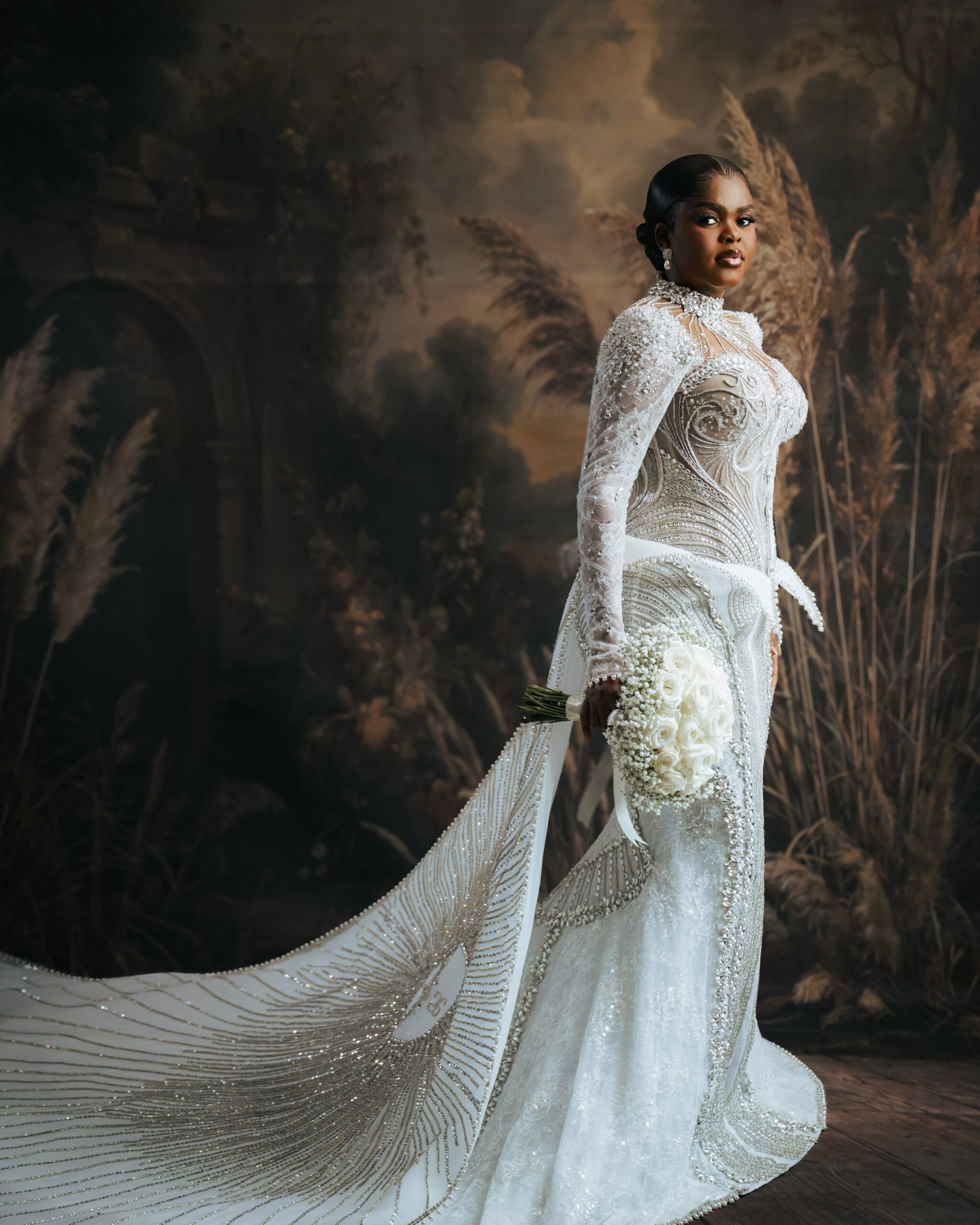 Jarvis showing off the embroidered cathedral-length train on her Veekee James wedding dress.