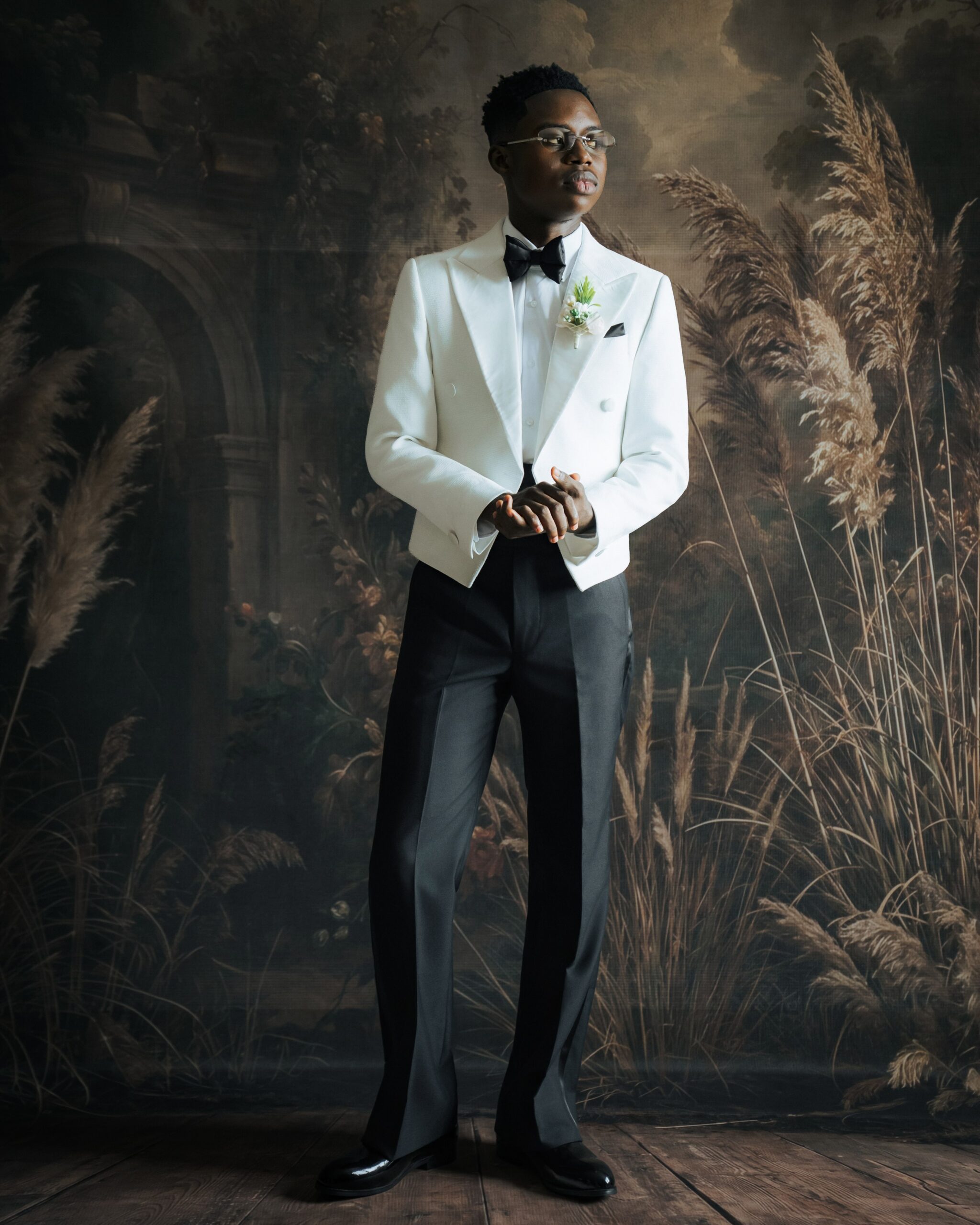 Peller posing in an off-white double-breasted T.I Nathan spencer jacket and black trousers.