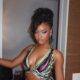 Ayra Starr posing in a printed pattern dress for her album Starrgirl
