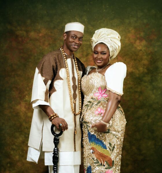 Close-up portrait of Lateef Adedimeji and Mo Bimpe smiling together in traditional Nigerian cream and gold outfits.