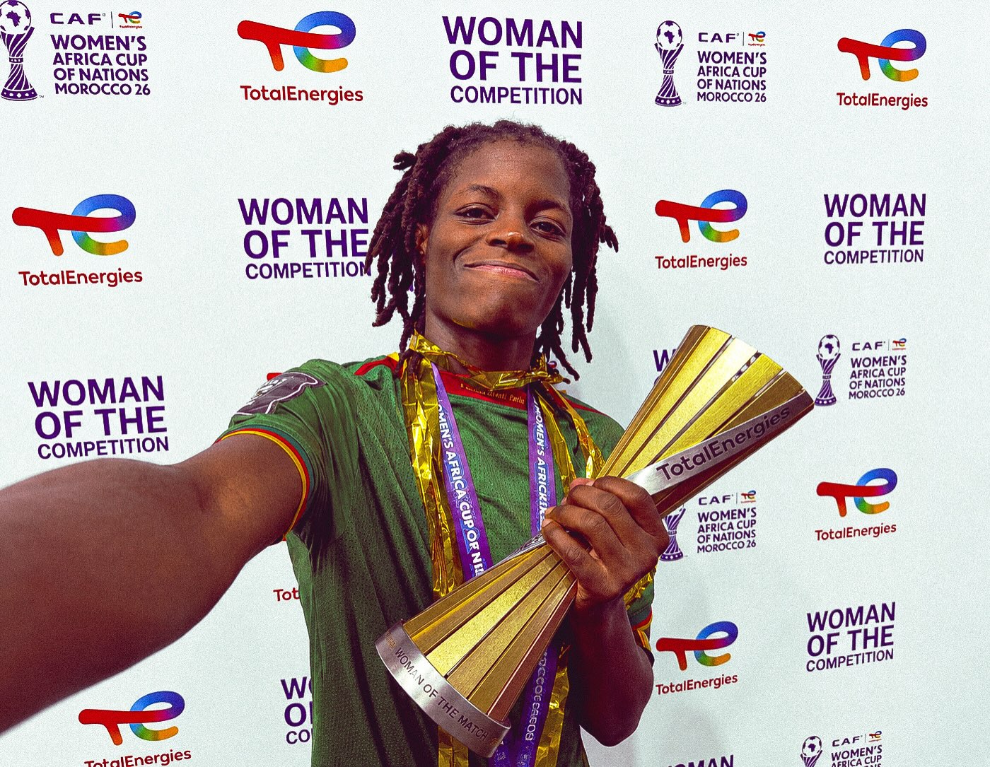 Monique Ngock taking a selfie with the Woman of the Competition trophy at WAFCON 2026.