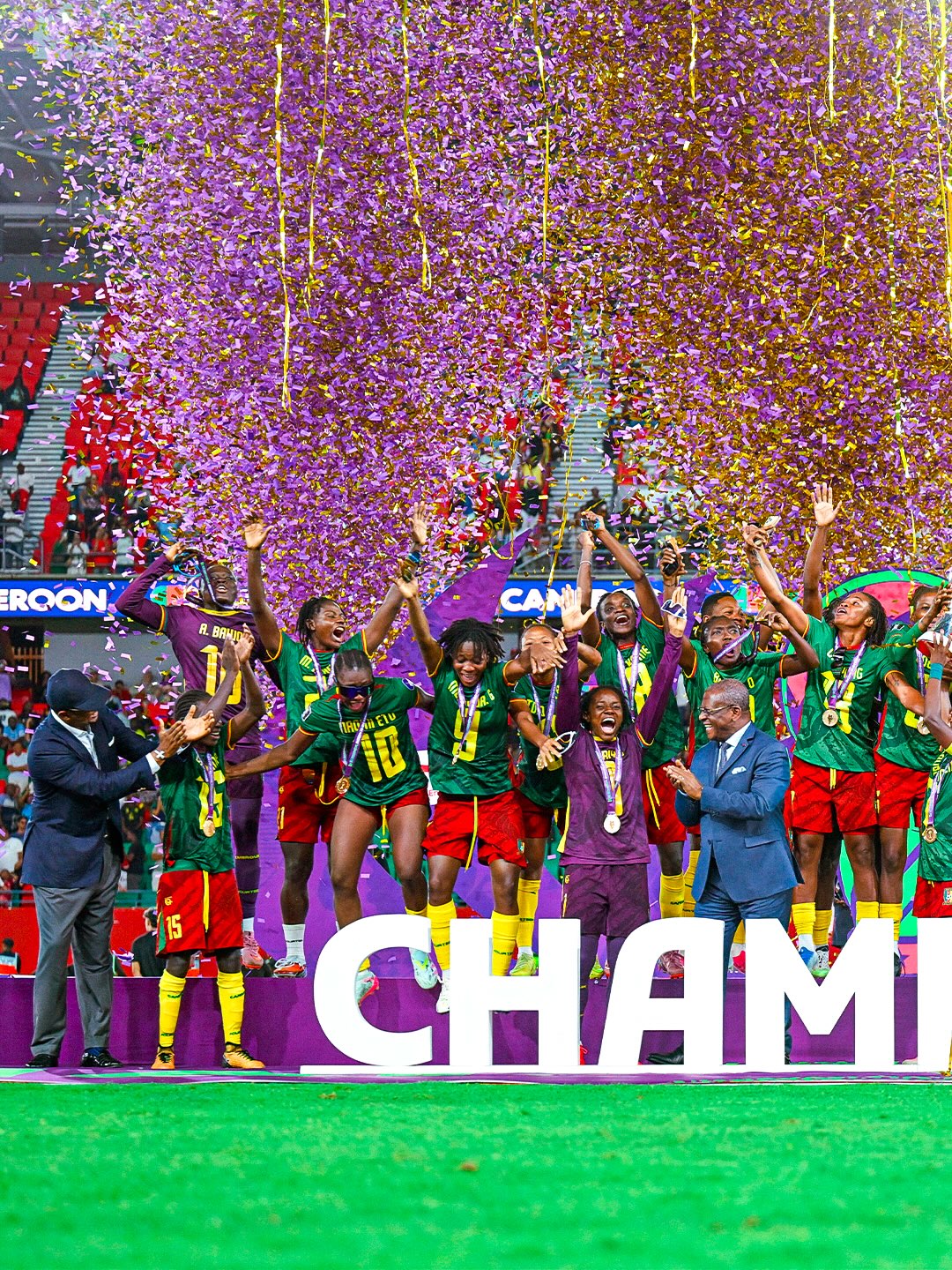Cameroon women's national team celebrating under confetti on the podium as WAFCON 2026 champions.