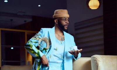 Ebuka Obi-Uchendu wearing a sky-blue double-breasted suit with wide-leg trousers and brown suede loafers.