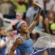 Coco Gauff smiling and waving to the crowd following her Cincinnati Open semi-final victory.