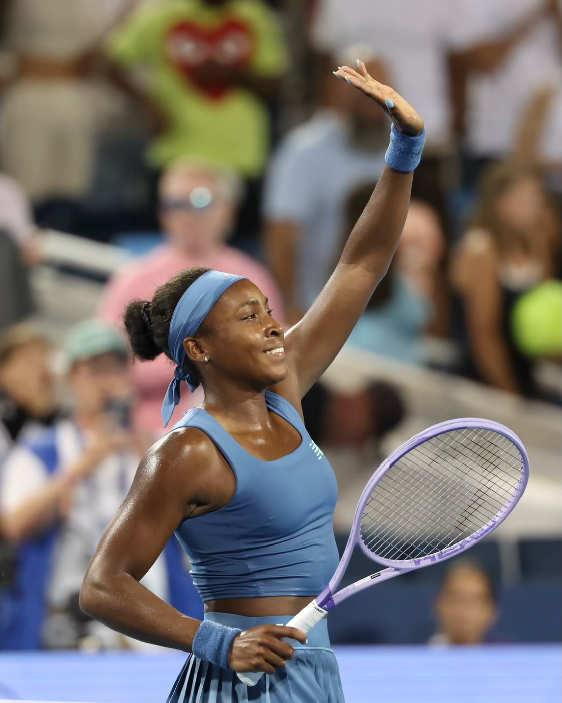 Coco Gauff smiling and waving to the crowd following her Cincinnati Open semi-final victory.