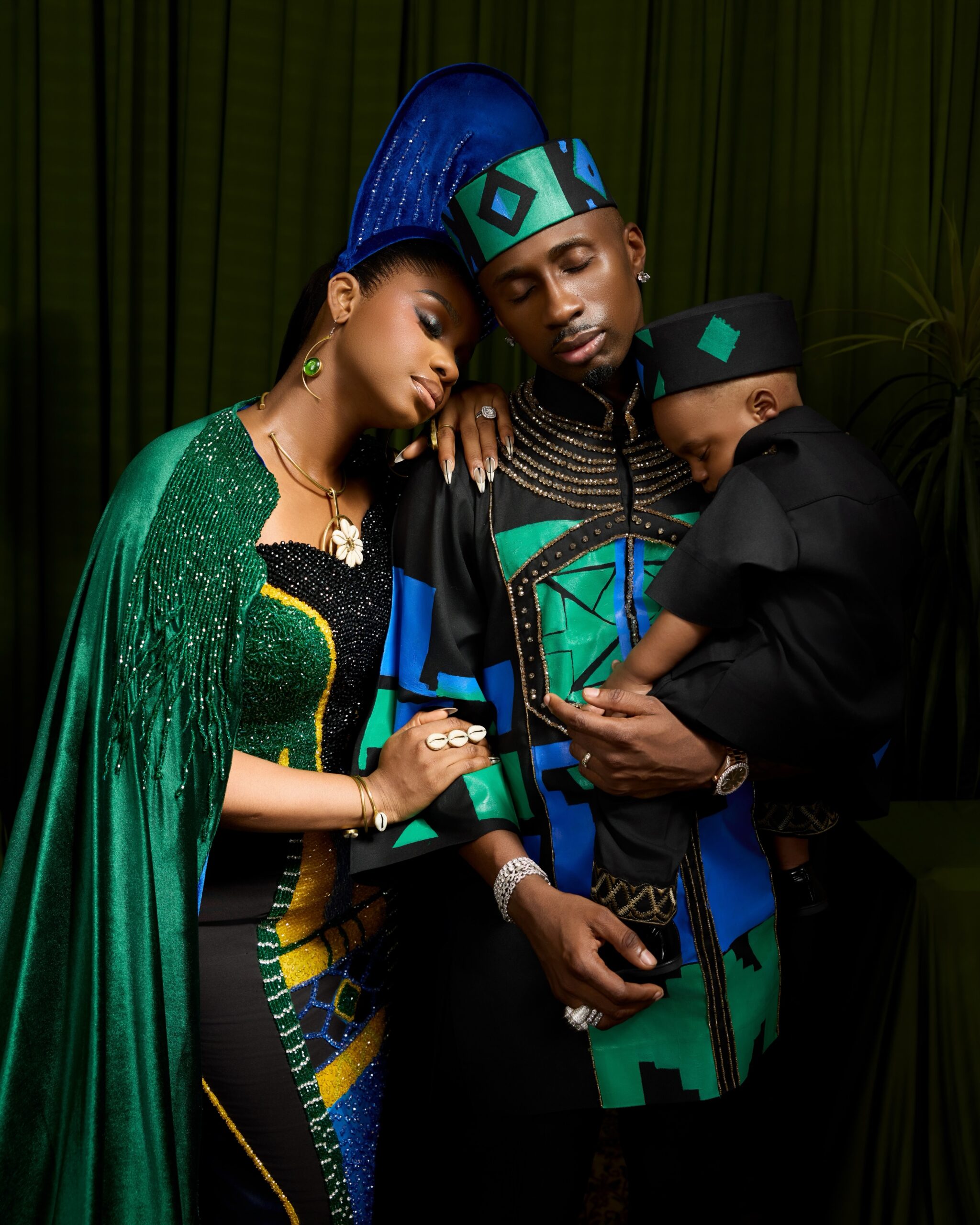 Priscilla Ojo resting her head on Juma Jux's shoulder as he holds their son Rakeem.
