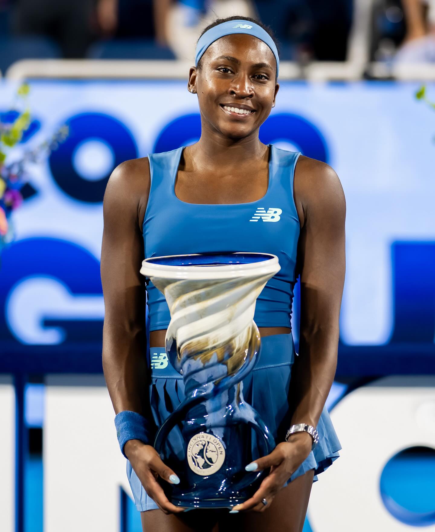 Coco Gauff smiling while holding the Rookwood Cup after winning the 2026 Cincinnati Open singles title.