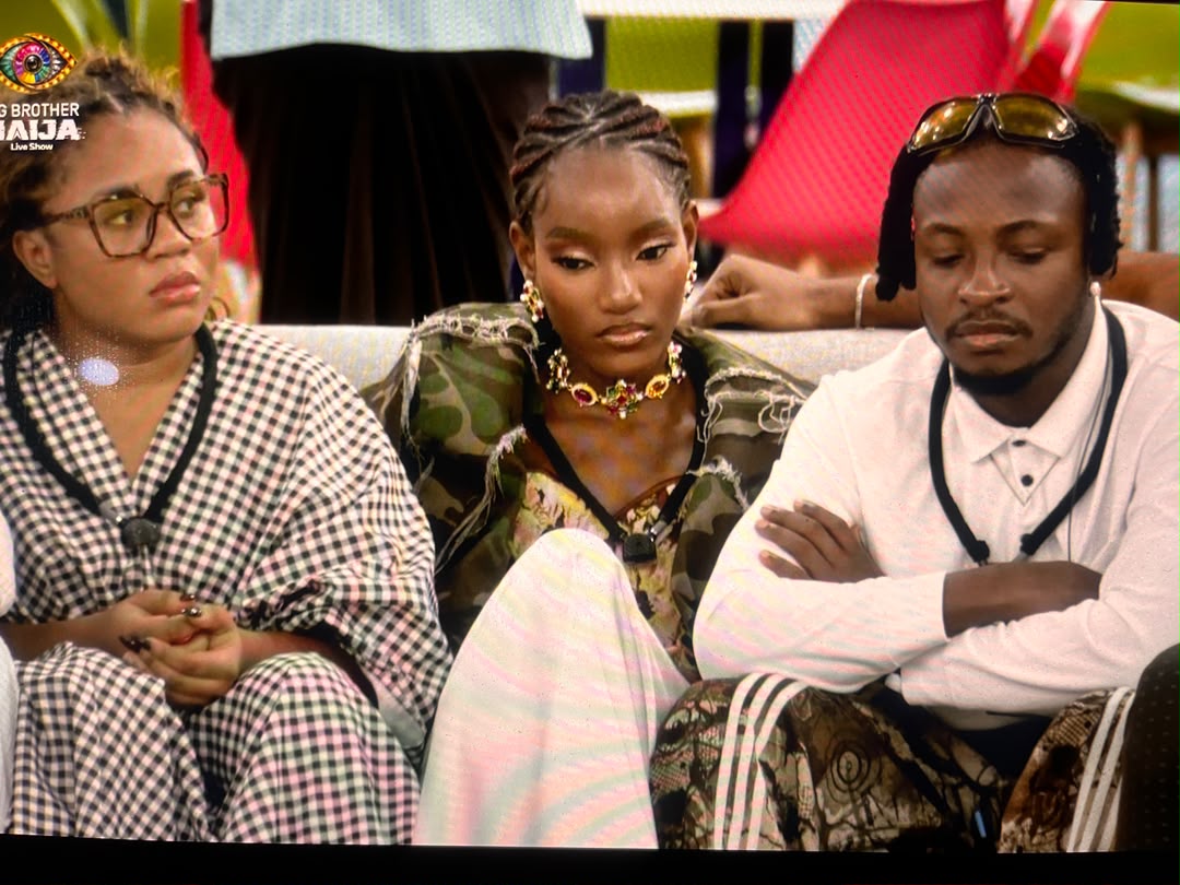 BBNaija Season 11 housemates Bells, Oyin, and Sultex sitting together on the couch during the live show.