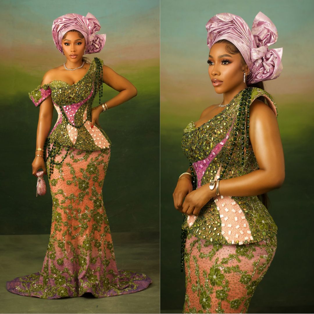 Mercy Eke wearing an asymmetric one-shoulder green and pink basque corset dress with a lilac Gele for Akin Faminu traditional wedding.