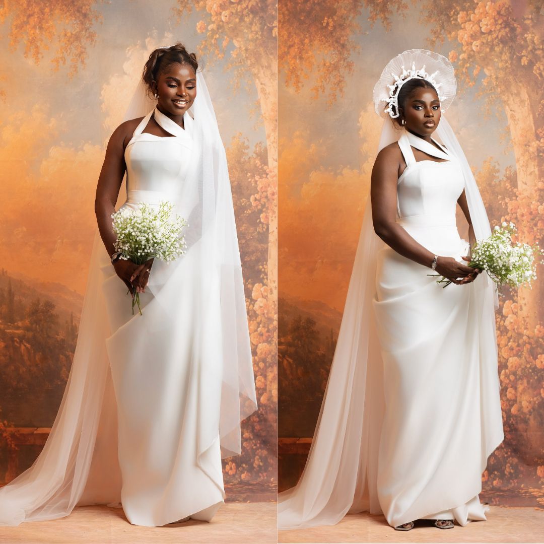 Prudent Gabriel wearing a halterneck white sheath gown with a trailing veil and a halo headpiece.