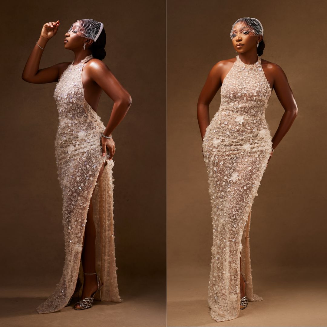 Omowunmi Dada in a halterneck embellished white lace gown and a mesh birdcage veil at the A Mama Deola Wedding Story premiere.