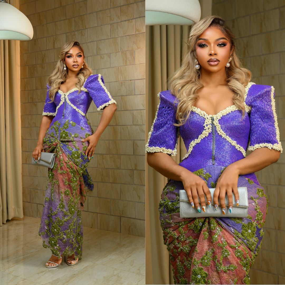 Roseline Afije (Liquorose) styled in a purple and green lace gown featuring white trimmed border seams and blonde waves for Akin Faminu traditional wedding.
