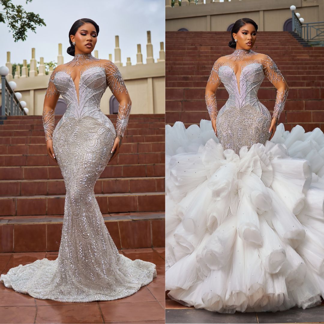 Content creator Diadem wearing a corset mermaid bridal gown with a exaggerated ruffled tulle train.