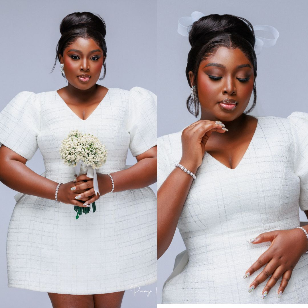 Mo Bimpe wearing a short tweed bridal dress with puff sleeves and carrying a white baby's breath bouquet.