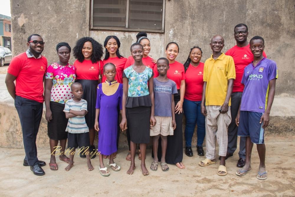 BellaNaija volunteers standing with the Odume family outside their home during 2016 BN Do Good outreach.