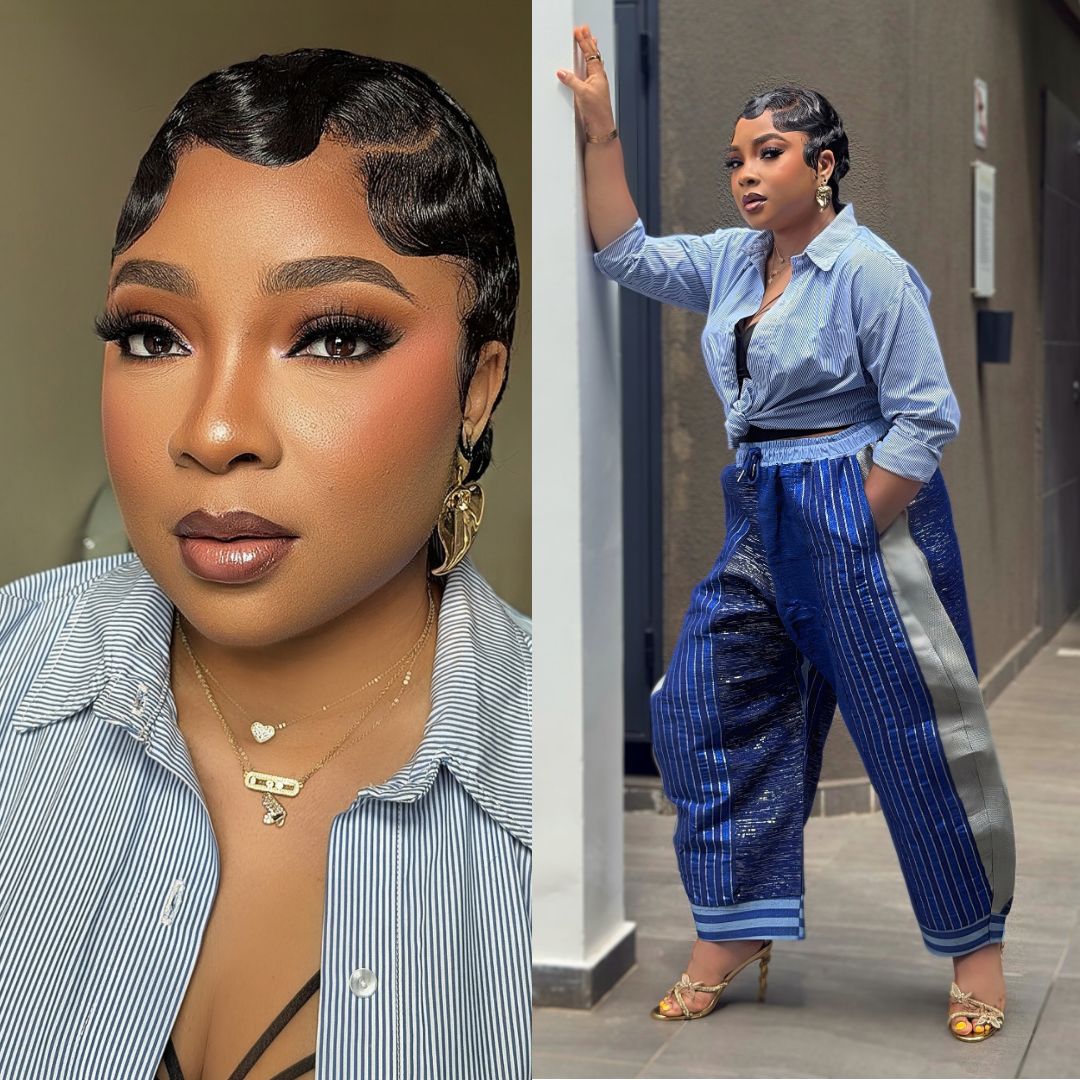 Linda Ejiofor Suleiman wearing a knotted pinstriped shirt, blue Aso-Oke utility trousers, and finger waves