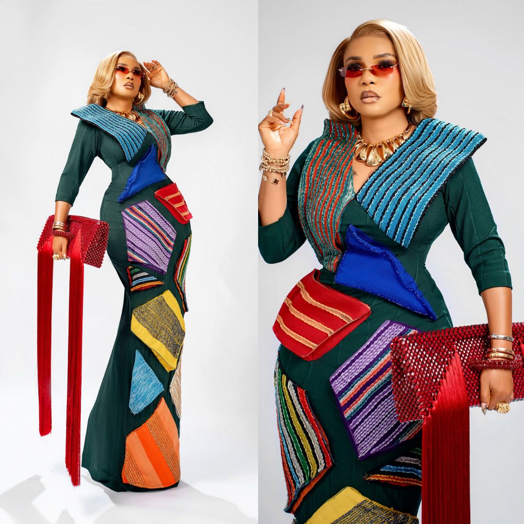 Iyabo Ojo wearing a green column gown with colourful geometric fabric panels at the Starlomo premiere.