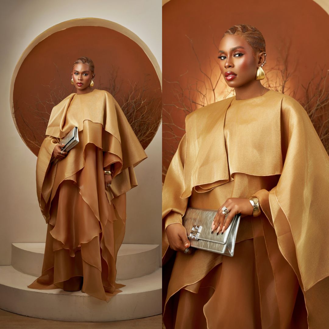 Lydia Lawrence-Nze wearing a metallic gold draped cape gown at the Starlomo movie premiere.