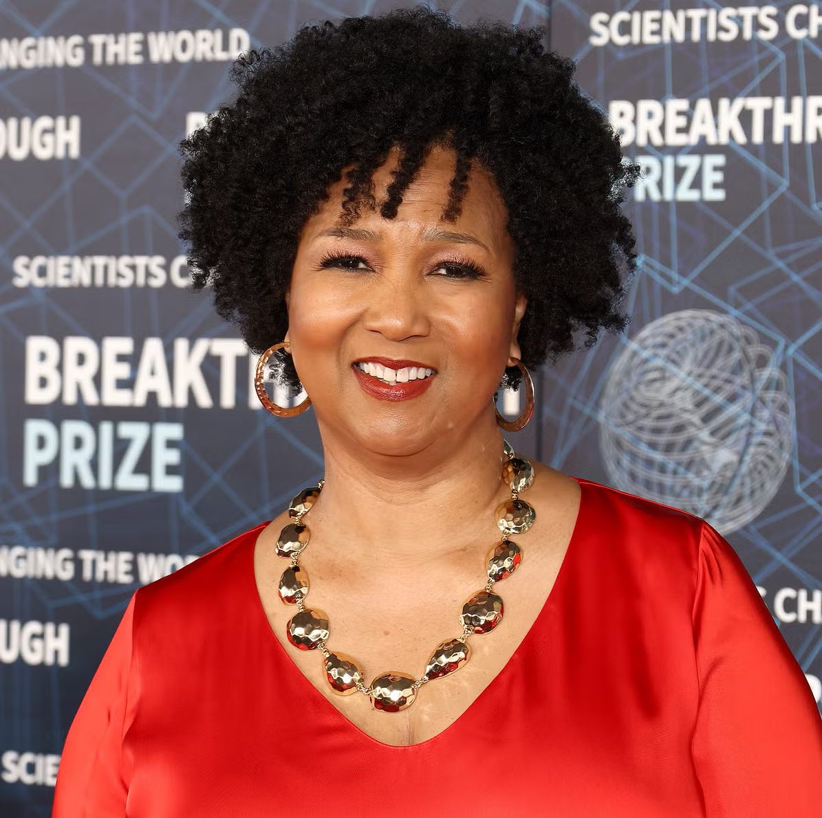 Dr Mae Jemison wearing a red dress and statement gold necklace at the Breakthrough Prize event.