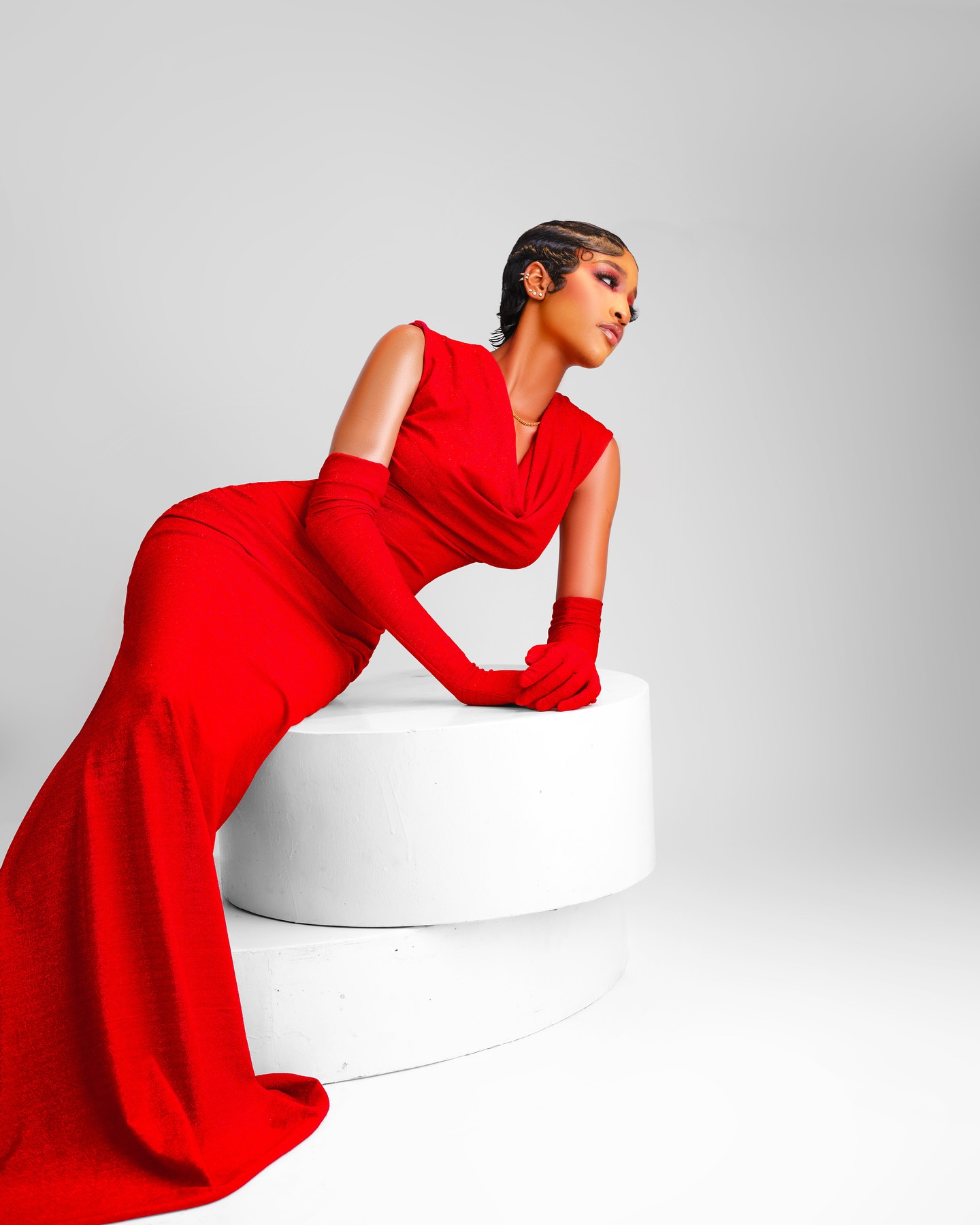 Usaku Bantai known as Bluethopia posing in a red cowl-neck evening gown before entering Big Brother Naija Season 11