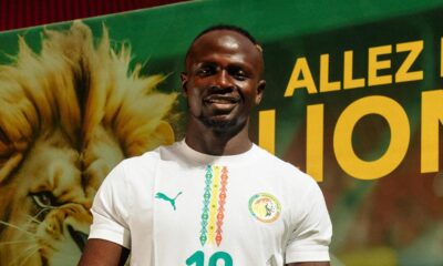Sadio Mané wearing the white Senegal national football team jersey with number 10 holding a match ball