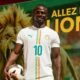 Sadio Mané wearing the white Senegal national football team jersey with number 10 holding a match ball