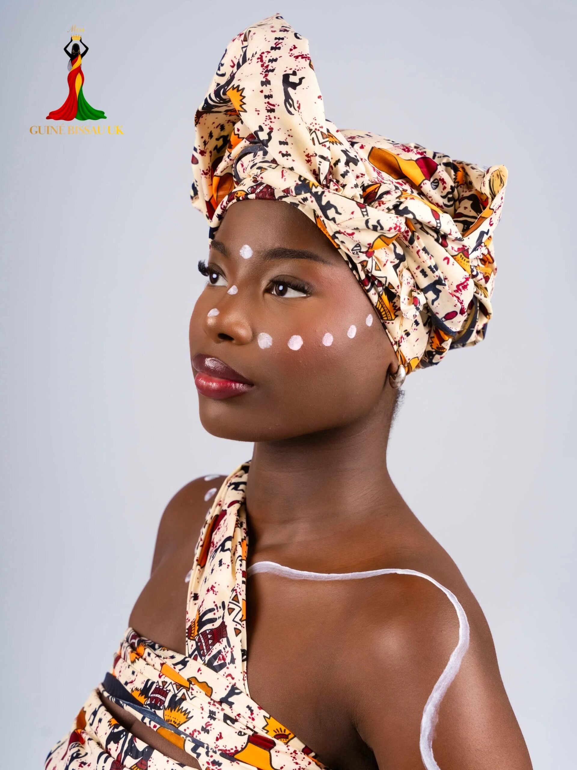 Jessica Cubala wearing traditional printed headwrap and body paint for Miss Guiné-Bissau UK 2026