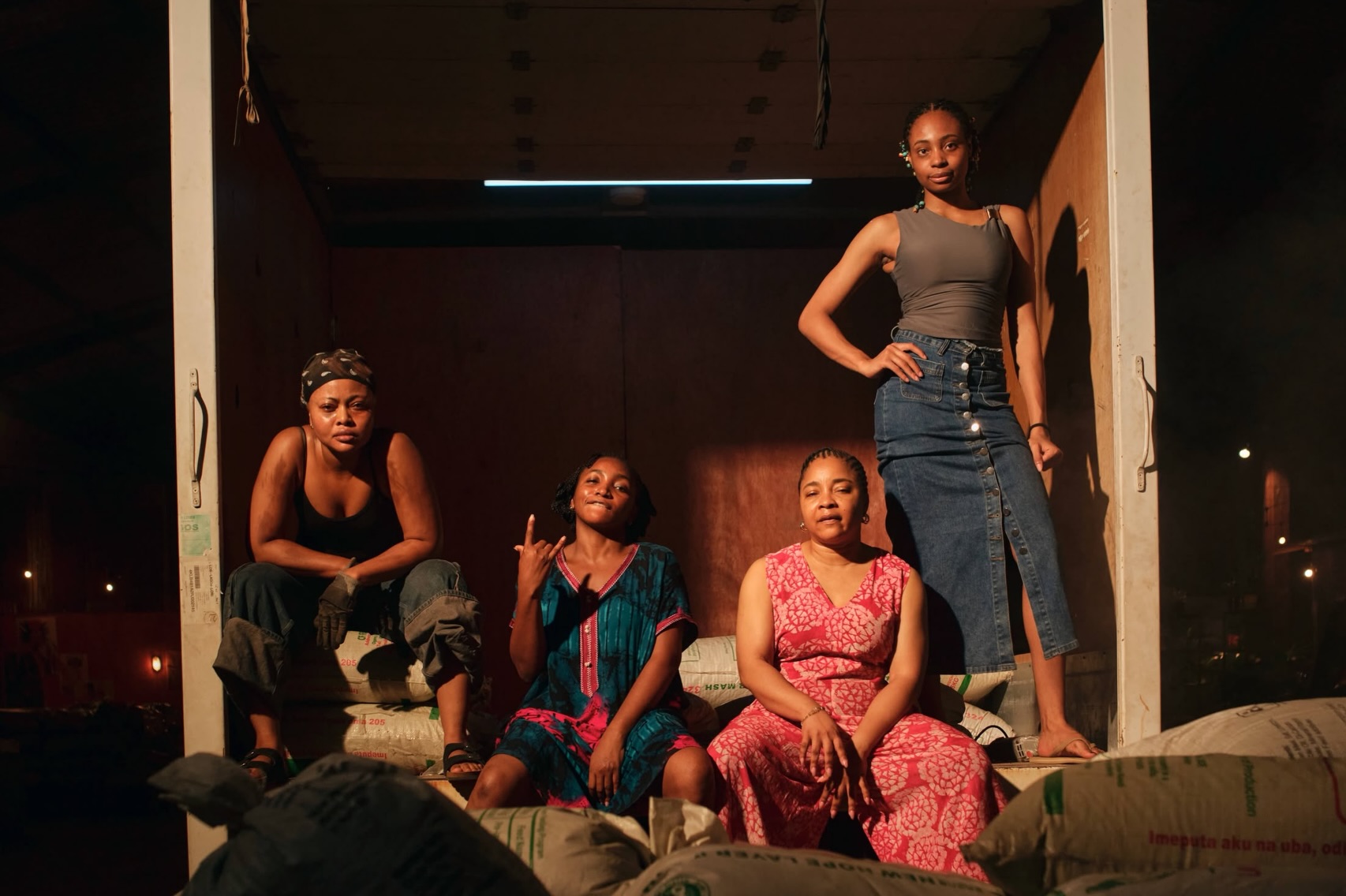 Omowunmi Dada, Teniola Aladese, Linda Ejiofor-Suleiman, and Susan Pwajok inside a cargo truck on the Black Market film set