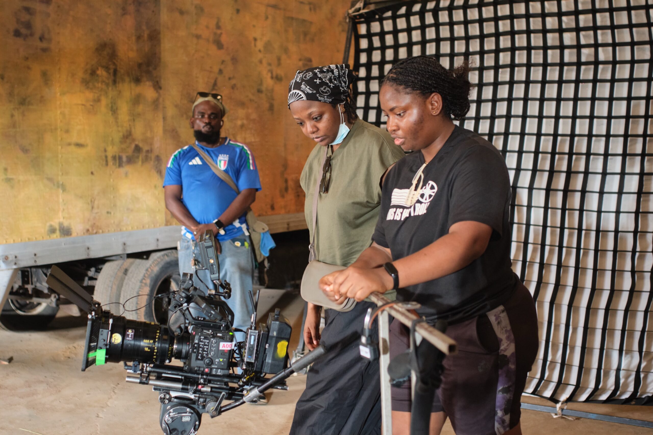 Producer Nora Awolowo and director Fatimah Binta Gimsay reviewing footage on camera monitor for Black Market