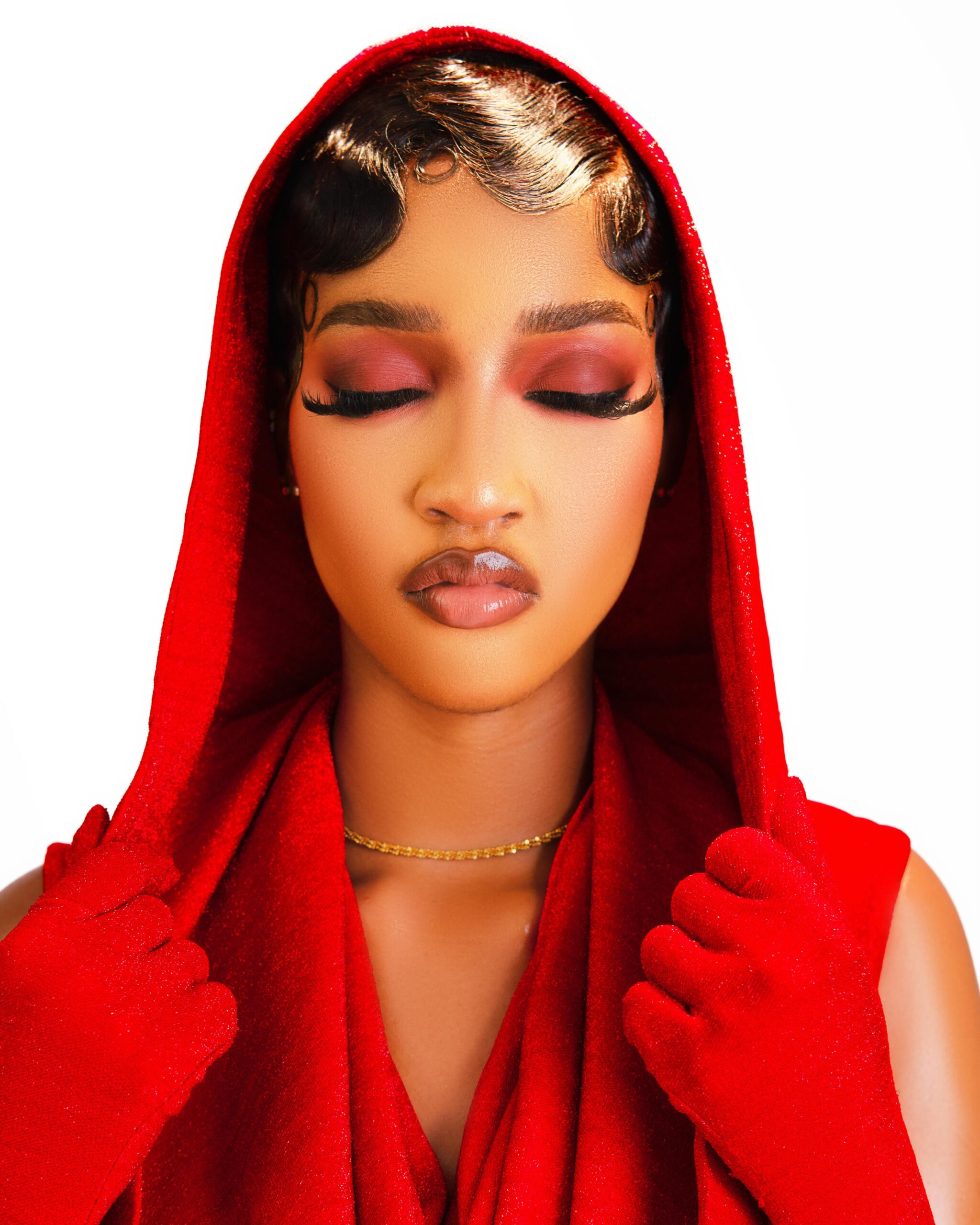 BBNaija 11 housemate Bluethopia wearing a red hooded outfit highlighting her creative styling background