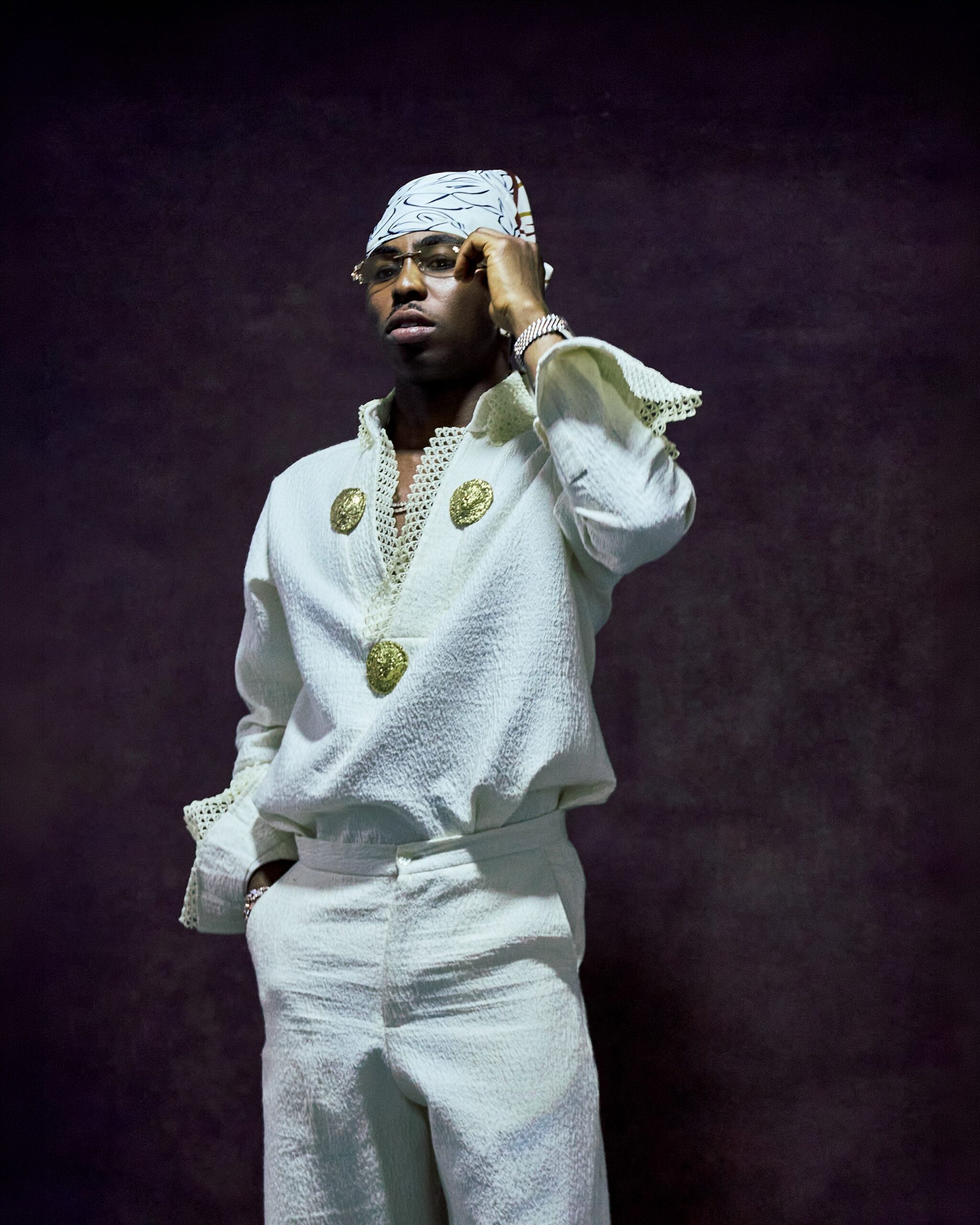 FOLA wearing an off-white textured tunic set accented with gold medallions