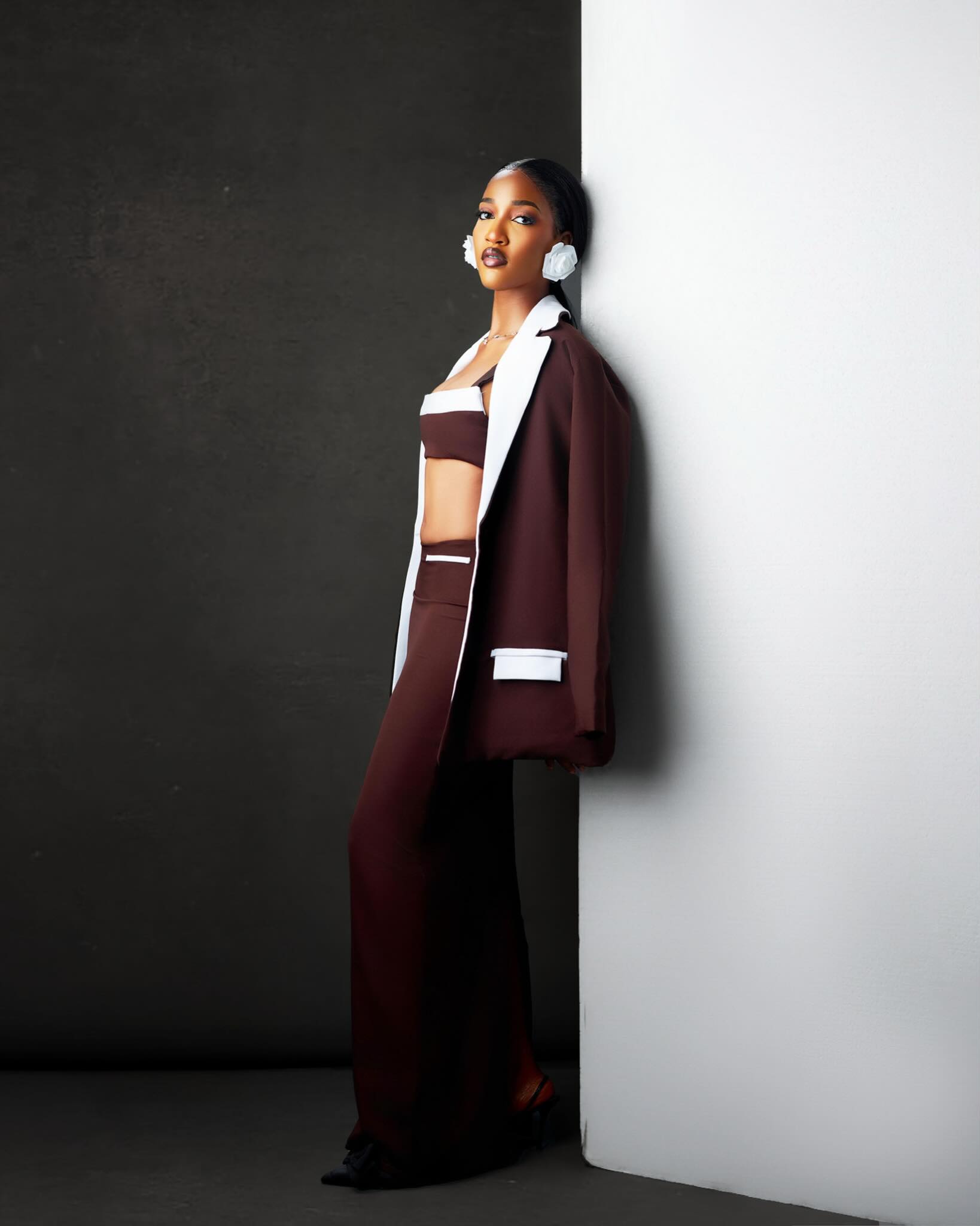 Usaku Bantai Bluethopia wearing a tailored brown two-piece skirt set with contrast lapels