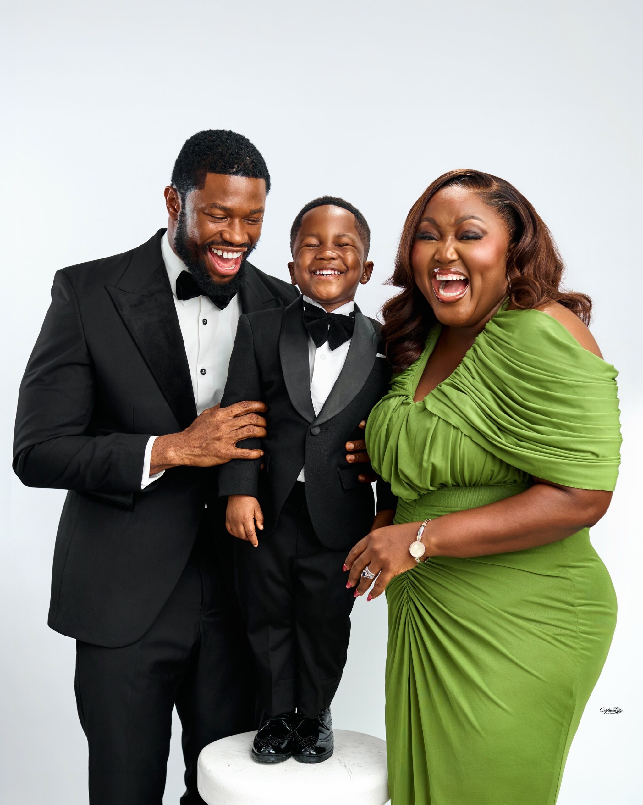 Blessing Obasi and Stan Nze laughing with their son Jayden in a 3rd birthday family photo shoot.