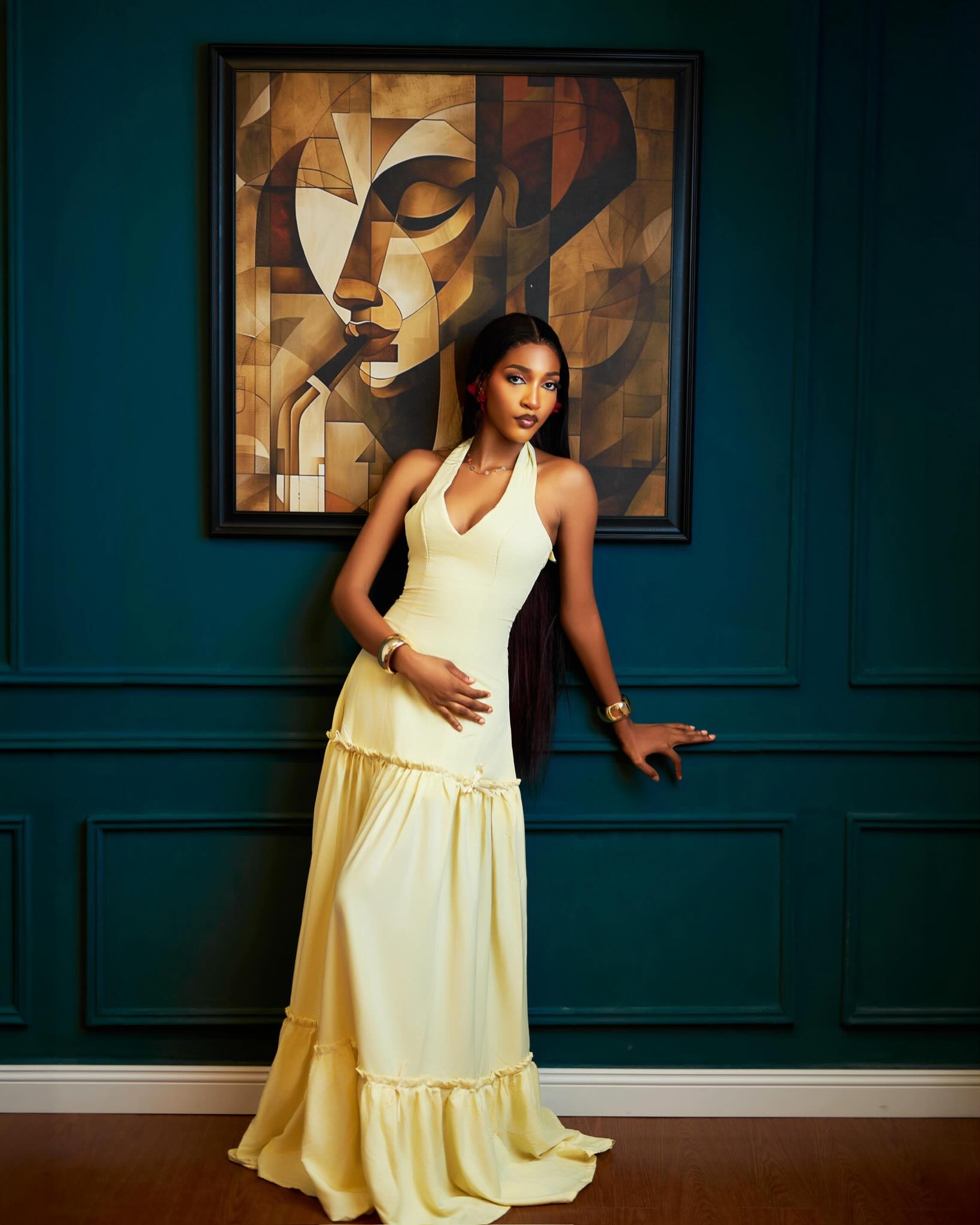 BBNaija housemate Bluethopia wearing a pale yellow halter-neck tiered maxi dress